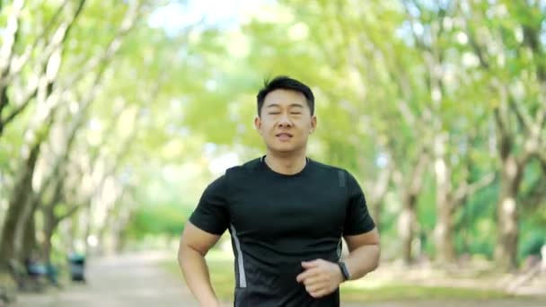 Asian Runner Jogging Urban City Park Looking Smart Watch Man — Stockvideo