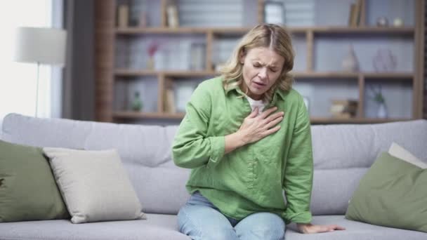 Sick Mature Blonde Woman Having Tension Heart Pain Sitting Living — Video Stock