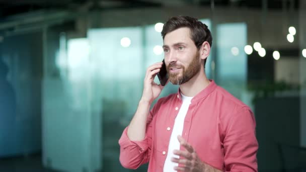 有信心的商人创业者自由职业者在现代办公室里用手机交谈成功的 忙碌的 留胡子的办公室职员在工作场所用智能手机进行专业的交谈 — 图库视频影像