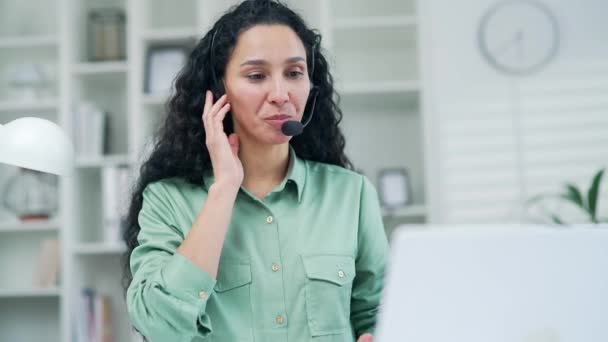 在无线耳机上为客户提供客户服务服务的公司运营商通过热线电话微笑女性代表呼叫中心代理帮助客户在办公室使用计算机处理投诉 — 图库视频影像