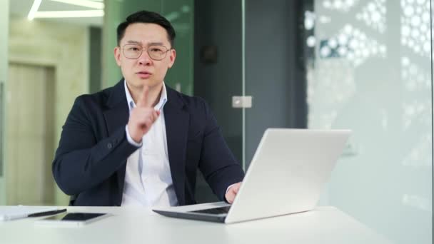 Asian Man Holding Index Finger Lips While Working Laptop While — Stock Video