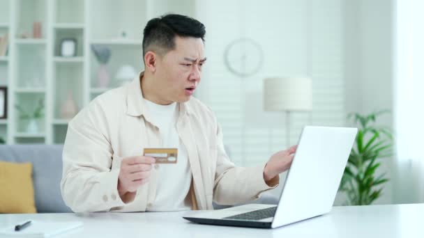 Sad Asian Businessman Discovered Fraud Entering Credit Card Number Laptop — Stock Video