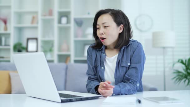 Asiatin Die Mit Dem Laptop Telefoniert Während Sie Hause Büro — Stockvideo