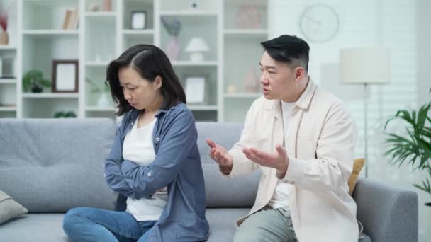 Enojado Marido Asiático Discutiendo Con Esposa Sentada Sofá Sala Estar — Vídeos de Stock