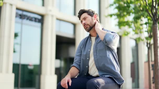 Mature Man Suffer Neck Pain Sitting Bench Modern Office Building — Stock Video