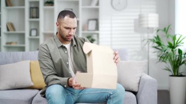 Kızgın, hoşnutsuz bir müşteri Arap 'a kötü bir alışveriş deneyimi olan bozuk bir paket kutusu veriliyor. Kutuyu açtıktan sonra kötü teslimat servisi üzgün hissediyor