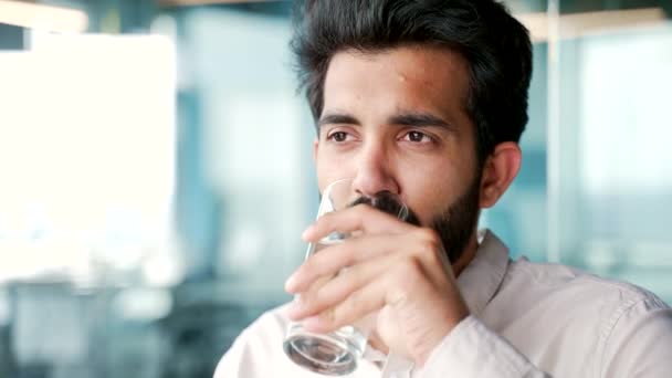 Close Young Bearded Man Shirt Drinks Water Glass While Sitting — Stock Video