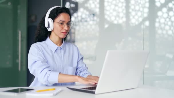 Young Confident Female Employee Headphones Typing Laptop While Sitting Workplace — Stock Video