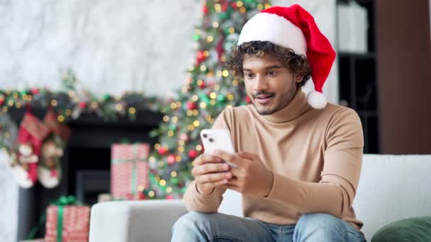 Happy Young Man Santa Hat Received Great News Smartphone Sitting — Stock Video
