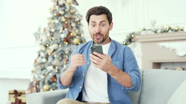 Happy Man Received Great News Smartphone While Sitting Sofa Home — Stock Video
