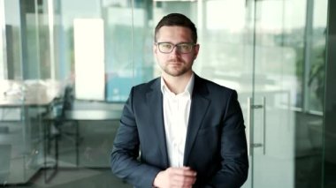 İş yerinde kollarını kavuşturmuş duran resmi takım elbiseli ve gözlüklü ciddi bir iş adamının portresi. İçerideki kameraya bakarak poz veren kendine güvenen girişimci. Müdürün kafasından.