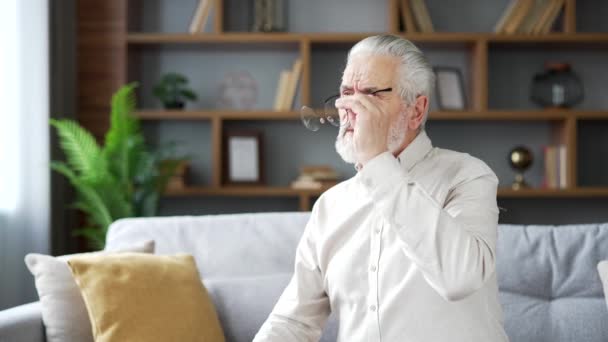 Vanhukset Vanhempi Harmaa Tukka Mies Kärsii Silmien Väsymys Istuessaan Sohvalla — kuvapankkivideo