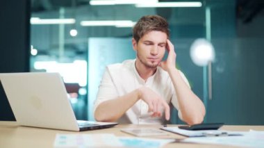 Kafası karışmış genç girişimci iş adamı muhasebe ve evrak işlerinde zorlanıyor. Endişeli erkek masrafları hesaplar, muhasebecilik yapar, sorunlu. Parasızlık, borç, ödenecek büyük vergiler.