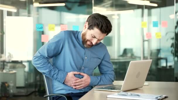 Upset Businessman Feels Stomach Pain While Working Laptop While Sitting — Stock Video