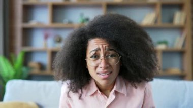 Webcam görüntüsü. Kötü haber okuyan Afro-Amerikalı genç bir kadının dizüstü bilgisayara bakıp evde oturmasına şaşırdım. Zenci kadın olumsuz tebliğden hayal kırıklığına uğramış, mesajdan depresyona girmiş.