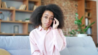 Webcam görüntüsü. Genç Afro-Amerikalı kadın evde kameraya bakarak online e-öğrenme, video kursu dinliyor. Siyahi kadın ders çalışıyor, uzaktan bir semineri ya da dersi izliyor, bir öğretmenle konuşuyor.