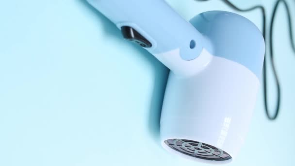 Vertical Video Hand Holding Blue Hair Dryer Blue Background — Stock Video