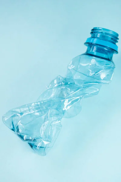 stock image Close up of plastic stripped bottle on blue background