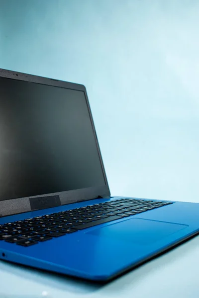 Modern blue laptop on blue background