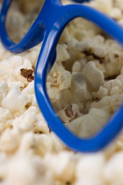 Close up of 3d cinema glasses in a popcorn pot