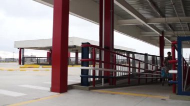 man walking up the ramp with a market car