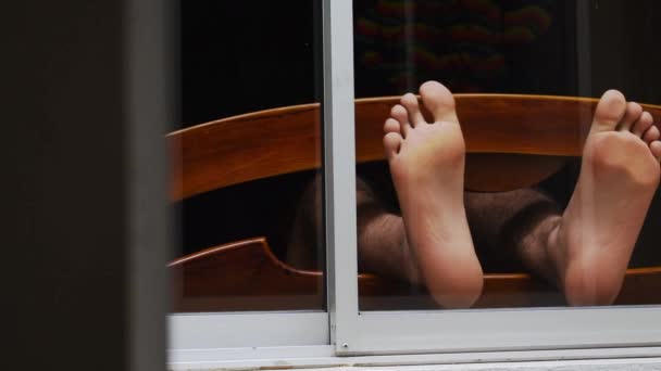Caucasian Man Playing His Feet Dark Window Bedroom Crossing His — Stock Video