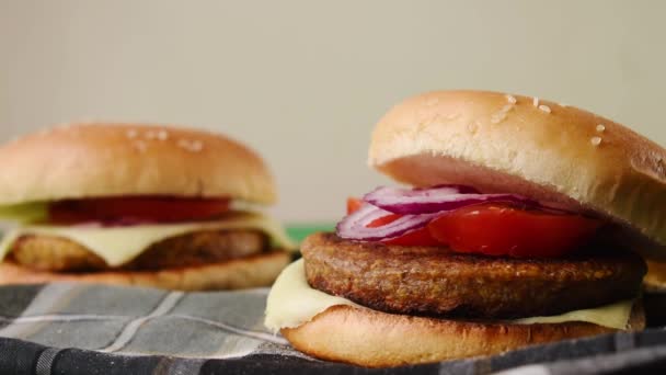 野菜とパンと手で1つを取るいくつかの新鮮なハンバーガー — ストック動画