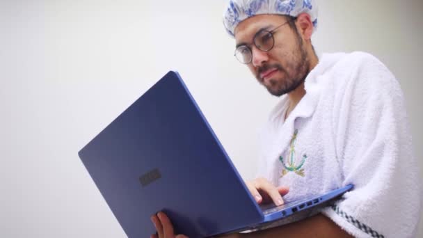 Homem Usando Toalha Touca Banho Olhando Laptop Azul — Vídeo de Stock