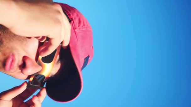 Pionowe Wideo Człowieka Noszącego Czapkę Okulary Przeciwsłoneczne Patrzącego Słońce Niebieskim — Wideo stockowe