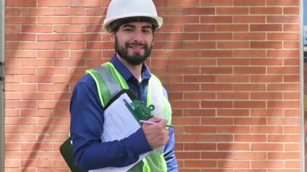 Latin Construction Worker Man Holding Documents Brick Wall Background Sunny — Stock Video