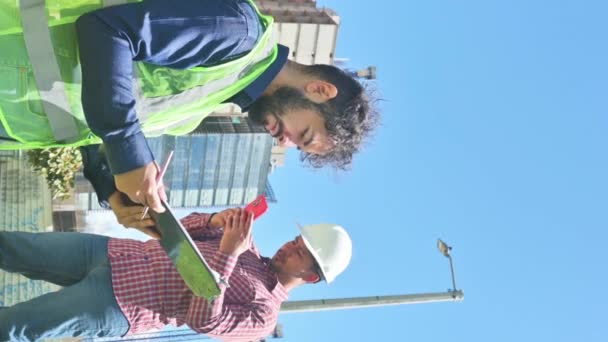 晴れた日の現場の建設労働者の垂直ビデオ — ストック動画