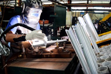 Sidoarjo, Indonesia - April 9, 2015: worker welding material the spare part on the assembly line at bicycle assembly from Indonesia Polygon in Sidoarjo, East Java, Indonesia