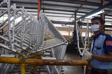 SIDOARJO, INDONESIA - APRIL 9, 2015: Worker checking on the assembly line at the assembly bicycle from Indonesia Polygon in Sidoarjo, East Java, Indonesia
