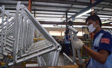 SIDOARJO, INDONESIA - APRIL 9, 2015: Workers check on the assembly line at the assembly bicycle from Indonesia Polygon in Sidoarjo, East Java, Indonesia