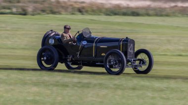 Old Warden, İngiltere - 2 Ekim 2022: Vintage yarış arabası 1914 Sunbeam çimen pisti boyunca hızla sürülüyor