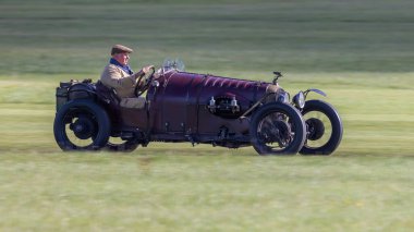 Old Warden, İngiltere - 2 Ekim 2022: Vintage araba 1929 Amilcar Riley çimen pisti boyunca hızla sürülüyor