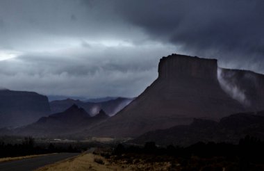 A passing rainstorm brings some clouds, fog and  dramatic looks to the landscape at Castle Valley, Utah clipart