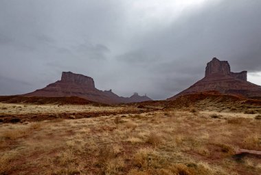 A passing rainstorm brings some clouds, fog and  dramatic looks to the landscape at Castle Valley, Utah clipart