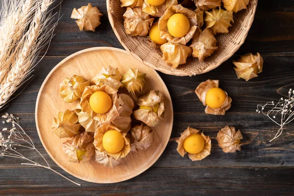 Cape gooseberry or golden berry (Physalis peruviana) on wooden background, Table top view