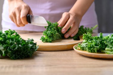 Green Kale or leaf cabbage cutting on wooden board, Healthy vegetable