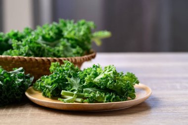 Sliced Green Kale or leaf cabbage on wooden plate, Healthy vegetable