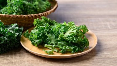 Green Kale or leaf cabbage on wooden plate, Healthy vegetable