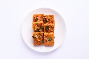 spicy braised tofu (Dubu Jorim) on white background, Korean side dish