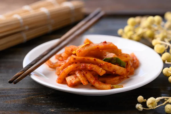Kimchi radish on wooden background, Korean food homemade side dish