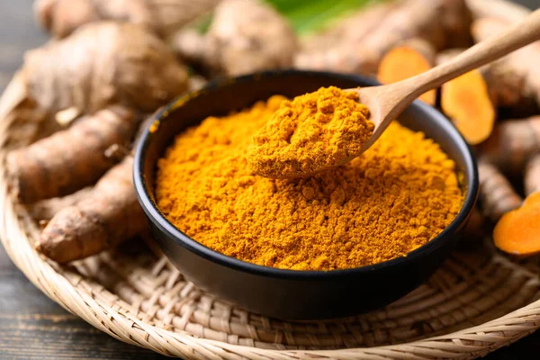 stock image Turmeric powder and fresh turmeric (Curcuma, curcumin), Organic ingredient in Asian cuisine, food coloring or natural dyeing