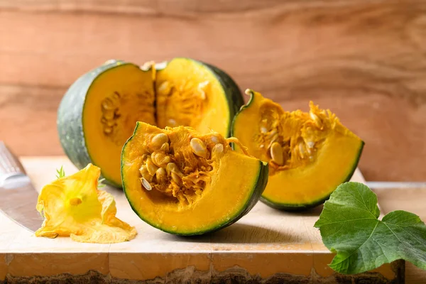 stock image Green Japanese pumpkin on wooden board prepare for cooking