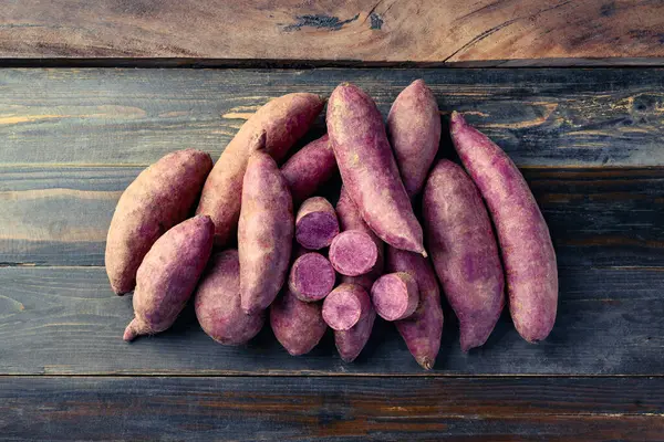 Purple sweet potato on wooden background, Table top view