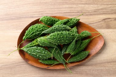 Ahşap zemin üzerinde acı kabak ya da acı kavun, Asya gıda malzemeleri ve bitkisel ilaç, masa üstü görünümü