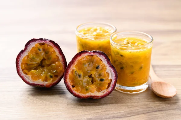 Passion fruit and juice on wooden background, Healthy fruit and drink
