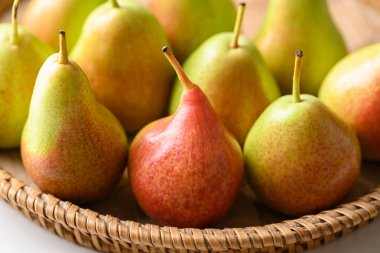 Fresh pear fruit in natural basket, Close up